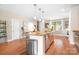 Kitchen featuring stainless steel appliances, a breakfast bar, and hardwood floors at 119 Steinbeck Way # E, Mooresville, NC 28117