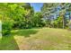 Lush green backyard adorned with mature trees, offering shade and a serene atmosphere at 1423 Ebinport Rd, Rock Hill, SC 29732