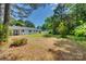 Lush backyard with mature trees and landscaping, perfect for outdoor enjoyment at 1423 Ebinport Rd, Rock Hill, SC 29732