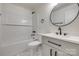 Stylish bathroom showcasing white subway tiles, a modern vanity, and a sleek, circular mirror at 1423 Ebinport Rd, Rock Hill, SC 29732
