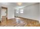 Bedroom features hardwood floors, a mirrored closet, and a window at 1423 Ebinport Rd, Rock Hill, SC 29732