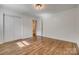 Bedroom featuring hardwood floors, neutral walls, closet, and abundant natural light from the windows at 1423 Ebinport Rd, Rock Hill, SC 29732