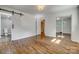 Empty bedroom featuring hardwood floors, an open door to the bathroom, and mirrored closet doors at 1423 Ebinport Rd, Rock Hill, SC 29732