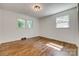 Bright bedroom featuring hardwood floors, neutral walls, and abundant natural light from the windows at 1423 Ebinport Rd, Rock Hill, SC 29732