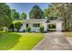 Charming white brick home with a covered carport and a well-manicured front yard at 1423 Ebinport Rd, Rock Hill, SC 29732