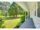 View from the covered porch of the well manicured front yard and mature shade trees at 1423 Ebinport Rd, Rock Hill, SC 29732