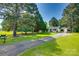 Charming home with a long driveway and mature trees in a well-manicured front yard at 1423 Ebinport Rd, Rock Hill, SC 29732