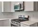 This kitchen features stainless steel appliances, white cabinets, gold hardware, and white countertops at 1423 Ebinport Rd, Rock Hill, SC 29732