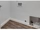 View of the laundry room hookups with wood-look floors at 1423 Ebinport Rd, Rock Hill, SC 29732