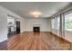 Open-concept living room with hardwood floors, a fireplace, and abundant natural light at 1423 Ebinport Rd, Rock Hill, SC 29732