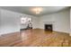Hardwood floors, fireplace and kitchen view highlight this home's bright, stylish living space at 1423 Ebinport Rd, Rock Hill, SC 29732
