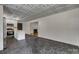 A wide angle view of the living area and kitchen with dark marble floors and fireplace at 1423 Ebinport Rd, Rock Hill, SC 29732