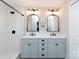Double vanity bathroom with decorative mirrors, modern lighting, and sleek fixtures at 1423 N New Hope Rd, Gastonia, NC 28054