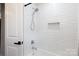 Bathroom showcasing a subway tile shower, modern fixtures, and a recessed shelf for added convenience at 1423 N New Hope Rd, Gastonia, NC 28054