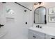 Updated bathroom features include tiled shower, shower niche, and vanity with elegant mirror at 1423 N New Hope Rd, Gastonia, NC 28054
