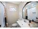 Bathroom with a modern sink, unique mirror, neutral color palette, and updated fixtures at 1423 N New Hope Rd, Gastonia, NC 28054