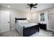 Cozy bedroom with a plush bed, ceiling fan, hardwood floors, and natural light from the windows at 1423 N New Hope Rd, Gastonia, NC 28054