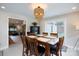 Bright dining room with a wooden table, stylish chandelier and sliding glass door to the backyard at 1423 N New Hope Rd, Gastonia, NC 28054