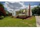 Charming home featuring a brick chimney, inviting front porch, and well-maintained lawn at 1423 N New Hope Rd, Gastonia, NC 28054