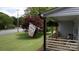 Inviting covered front porch with a 'Welcome' flag and manicured lawn at 1423 N New Hope Rd, Gastonia, NC 28054