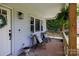 Inviting covered front porch with stylish seating, potted plants, and charming details enhancing the home's curb appeal at 1423 N New Hope Rd, Gastonia, NC 28054