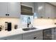 Bright kitchen featuring white subway tile backsplash, quartz countertops, and stainless steel appliances at 1423 N New Hope Rd, Gastonia, NC 28054
