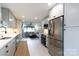 Modern kitchen featuring stainless steel appliances and ample cabinet space with an open view into the living room at 1423 N New Hope Rd, Gastonia, NC 28054