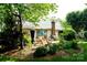 Picturesque backyard featuring a patio with outdoor furniture, lush landscaping, and mature trees at 14406 Gadwall Ct, Charlotte, NC 28273