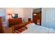 A bedroom with white walls, light-colored bedspread, and wooden furniture at 14406 Gadwall Ct, Charlotte, NC 28273