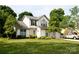 Beautiful two-story home boasting a well-kept lawn, mature trees, and a two-car garage, radiating suburban charm at 14406 Gadwall Ct, Charlotte, NC 28273