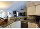 Kitchen featuring granite counters, stainless appliances, eat-in bar, and view to billiard room at 14406 Gadwall Ct, Charlotte, NC 28273