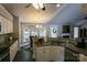 Open-concept kitchen featuring granite counters, white cabinets, and eat-in breakfast nook at 14406 Gadwall Ct, Charlotte, NC 28273