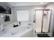 Main bathroom featuring a soaking tub, a standing shower, and a decorative tile surround at 14406 Gadwall Ct, Charlotte, NC 28273