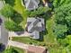Aerial view of home with a large lawn, mature trees, and a long driveway at 1506 Ivy Bluff Way, Matthews, NC 28105