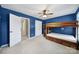 This bedroom features blue walls and a wooden bunk bed between two white doors at 1506 Ivy Bluff Way, Matthews, NC 28105
