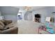 The bonus room has a comfortable couch, TV, and table with ample space for activities at 1506 Ivy Bluff Way, Matthews, NC 28105