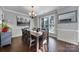 Charming dining room featuring natural light, a large wooden table, and stylish decor makes it great for gatherings at 1506 Ivy Bluff Way, Matthews, NC 28105