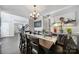 Elegant dining room with a large wooden table, stylish chandelier, and tasteful decor perfect for entertaining at 1506 Ivy Bluff Way, Matthews, NC 28105