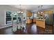 Eat-in kitchen featuring wood cabinets, granite countertops, stainless appliances, and plenty of natural light at 1506 Ivy Bluff Way, Matthews, NC 28105