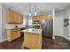 Open concept kitchen with granite counters, stainless appliances, an island and wood cabinets at 1506 Ivy Bluff Way, Matthews, NC 28105
