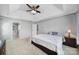 Spacious main bedroom with a tray ceiling, ceiling fan, carpet, and ensuite bathroom with glass shower at 1506 Ivy Bluff Way, Matthews, NC 28105
