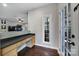 Entryway workspace features a built-in desk, lots of cabinets, and hardwood floors at 1506 Ivy Bluff Way, Matthews, NC 28105