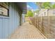 Backyard with an stone paver walkway, a wooden fence, and easy access to outdoor living at 1513 Landis Ave, Charlotte, NC 28205
