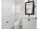Bright bathroom featuring shiplap walls, a modern vanity, and decorative tile flooring for a stylish and clean design at 1513 Landis Ave, Charlotte, NC 28205