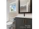 Well-lit bathroom with a modern vanity, neutral walls, and a view from the window, creating a comfortable space at 1513 Landis Ave, Charlotte, NC 28205