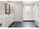 Well-appointed bathroom featuring sleek black tile floors, a double vanity, a standalone tub, and a glass shower at 1513 Landis Ave, Charlotte, NC 28205