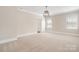 Bright bedroom featuring neutral walls, plush carpeting, and abundant natural light through multiple windows at 1513 Landis Ave, Charlotte, NC 28205