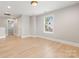 Bright bedroom featuring hardwood floors, natural light streaming through the window, and neutral walls at 1513 Landis Ave, Charlotte, NC 28205