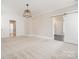 Spacious bedroom with ample natural light, a modern light fixture, and convenient access through a sliding barn door at 1513 Landis Ave, Charlotte, NC 28205