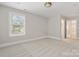 A bedroom with neutral carpet and walls, filled with natural light, offering a peaceful retreat at 1513 Landis Ave, Charlotte, NC 28205